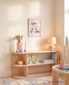 Love God Love Others Christian poster displayed above a light wood console in a softly lit pastel room