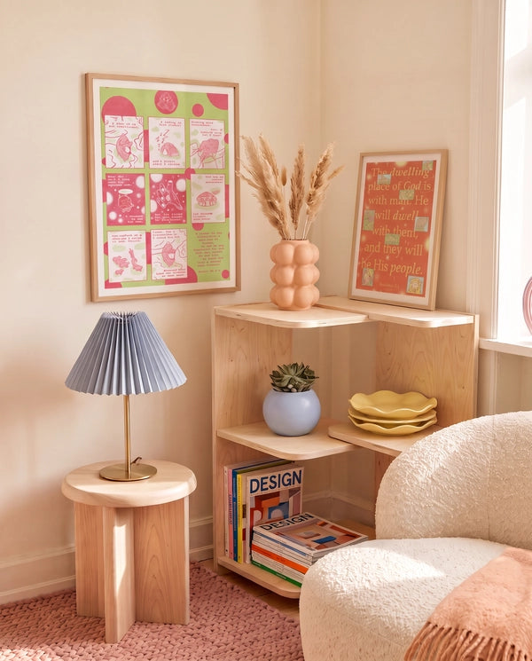 Love Has Brought Me Back Home pink and green Psalm 68:5–6 Christian poster displayed in a warm living room with wooden shelving and soft decor