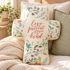 Love Is Patient Love Is Kind cross plush toy styled on a cosy sofa