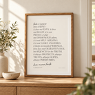 Love Is Patient Love Is Kind Christian poster framed in a bright sunlit home interior.