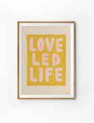 Love Led Life Christian poster inspired by 1 Corinthians 16:14 in a natural wood frame on a white background