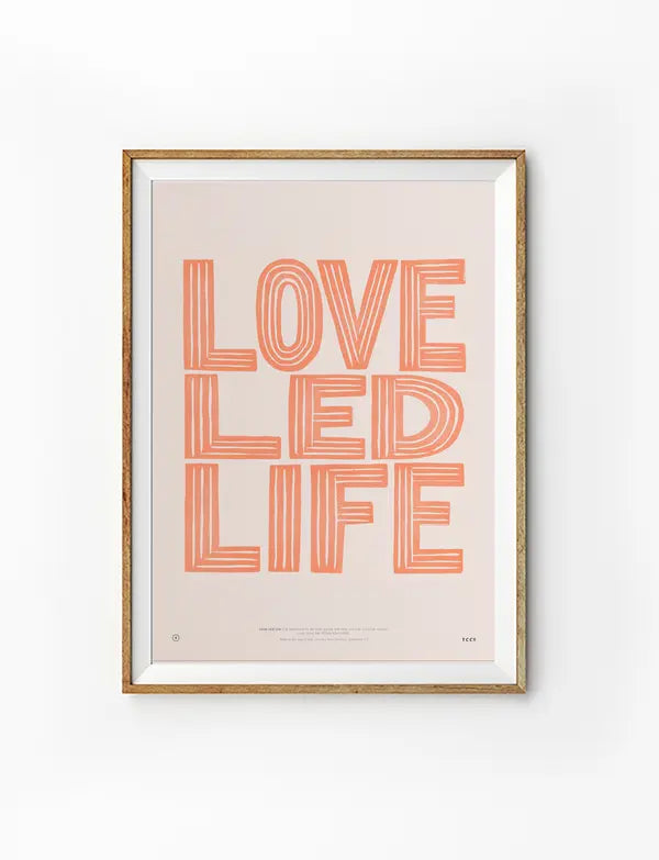 Framed Love Led Life Christian poster with coral striped lettering on a soft blush background