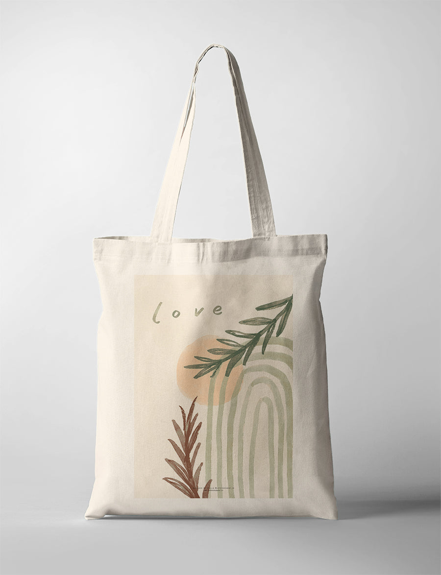 Minimalist Christian tote bag featuring the word “Love” with abstract arches, soft peach tones, and botanical illustrations