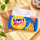 Love More Chocolate Chip Biscuit LOVE SUPERMARKET Christian card styled with an envelope on a bright tabletop.