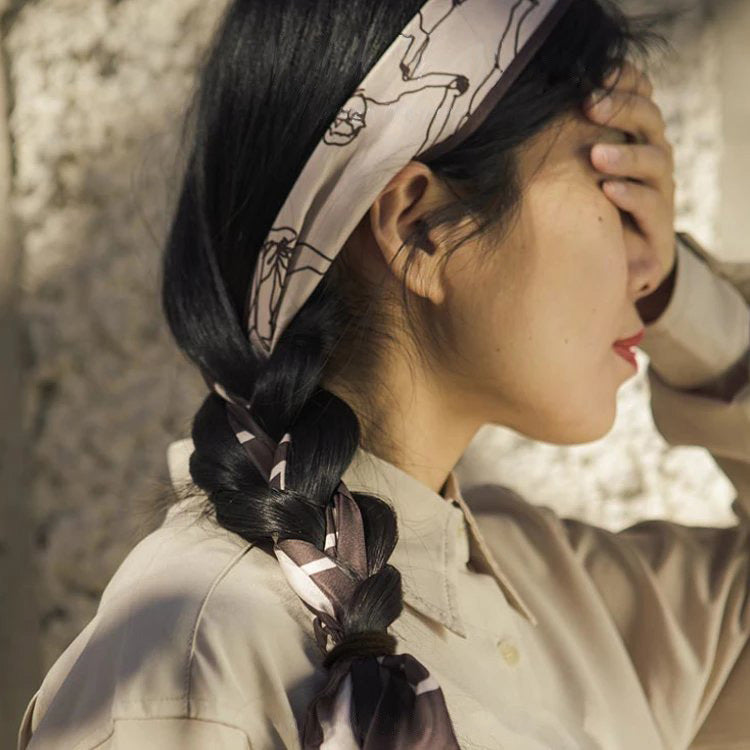 Love Song faux-silk scarf styled as an occasion-ready accessory.