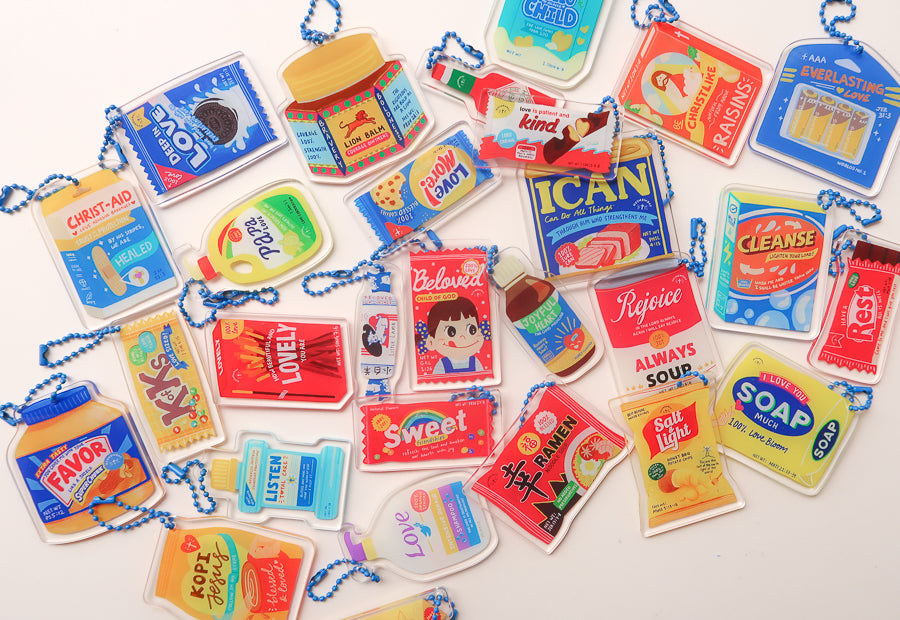 Colourful LOVE SUPERMARKET acrylic keychains with playful everyday-item designs.