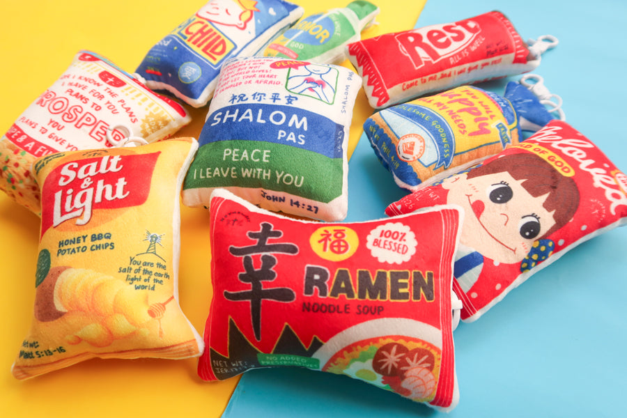 Love Supermarket plushie keychain collection featuring Blessed Ramen, Salt & Light, Shalom Pas, Beloved, and other faith-inspired snack designs.