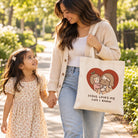 Loved by Jesus Always tote bag worn by a mother walking outdoors with her daughter
