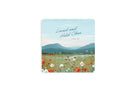 Christian coaster with “Loved and Held Close” and 1 Peter 4:8 featuring a peaceful floral field scene with mountains and soft pastel sky
