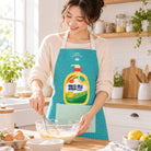 Mama Love Christian apron worn while baking in a bright home kitchen.