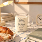 Maybe you are dissatisfied glass mug with handwritten encouragement on a sunlit desk with books and breakfast