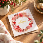 Merry Christmas Autumn watercolour floral wreath postcard with kraft envelope on a wooden table decorated for Christmas