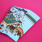 Close-up of teal Miracles of Jesus ang pao packets with illustrated scenes