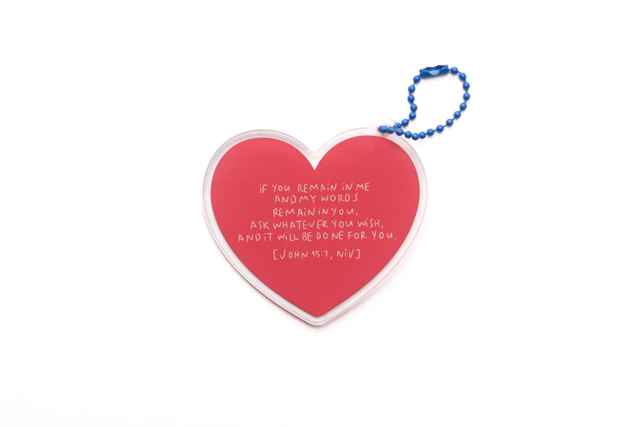 Heart-shaped acrylic keychain featuring the Bible verse John 15:7 in soft red tones, a Christian encouragement design in collaboration with moojigae_drawing.
