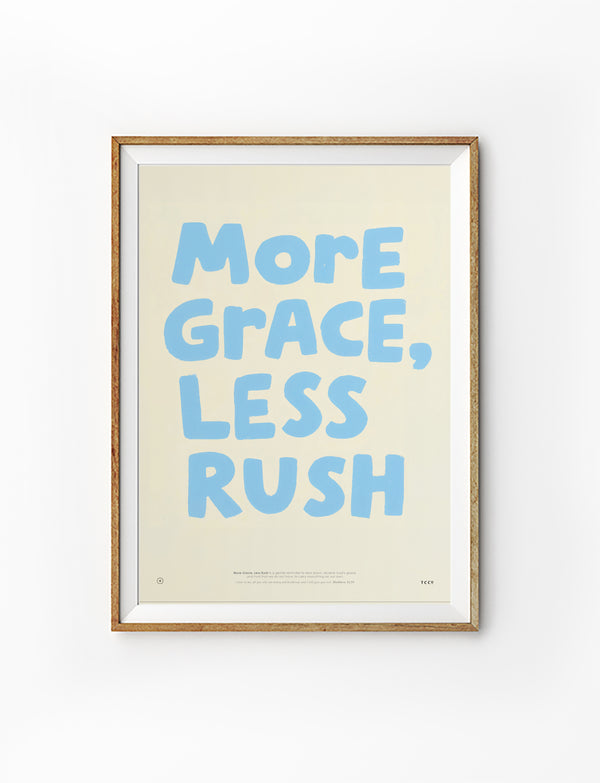 Framed More Grace Less Rush Christian poster with soft blue lettering on a warm cream background