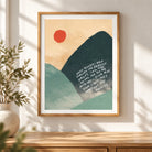 Mountains and Valleys Psalm 23 Christian poster displayed in a wooden frame on a warm sunlit wall.