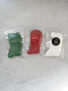 Three ribbed knit socks in green, red, and cream, each in clear packaging with circular labels; features the phrases “Always Hallelujah” and “Always Be Grateful” for a Christian gift and daily faith reminder.
