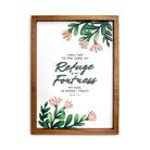 A wooden-framed wall art featuring the scripture "My Refuge and My Fortress, My God, in whom I trust" from Psalm 91:2, surrounded by delicate green leaves and pink flowers, perfect for Christian home decoration.