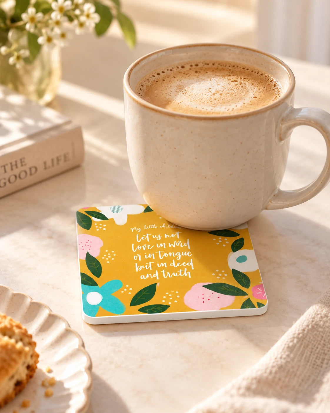 My Little Children floral Scripture coaster with white sides beneath a ceramic coffee mug on a sunlit breakfast table