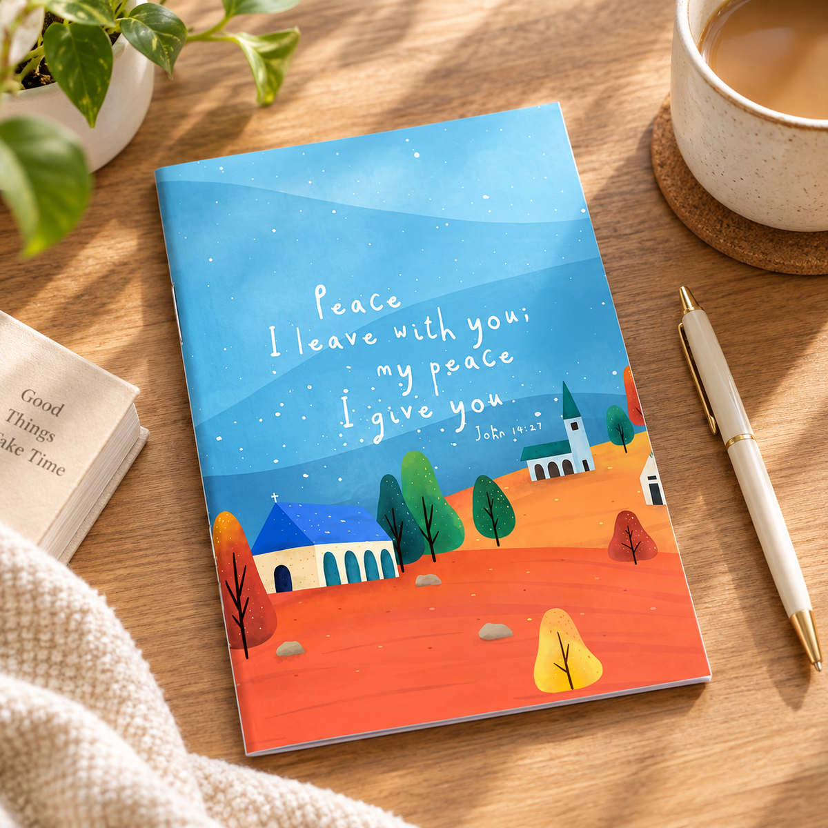 My Peace I Give You A6 Christian notebook styled on a warm wooden desk with coffee and stationery