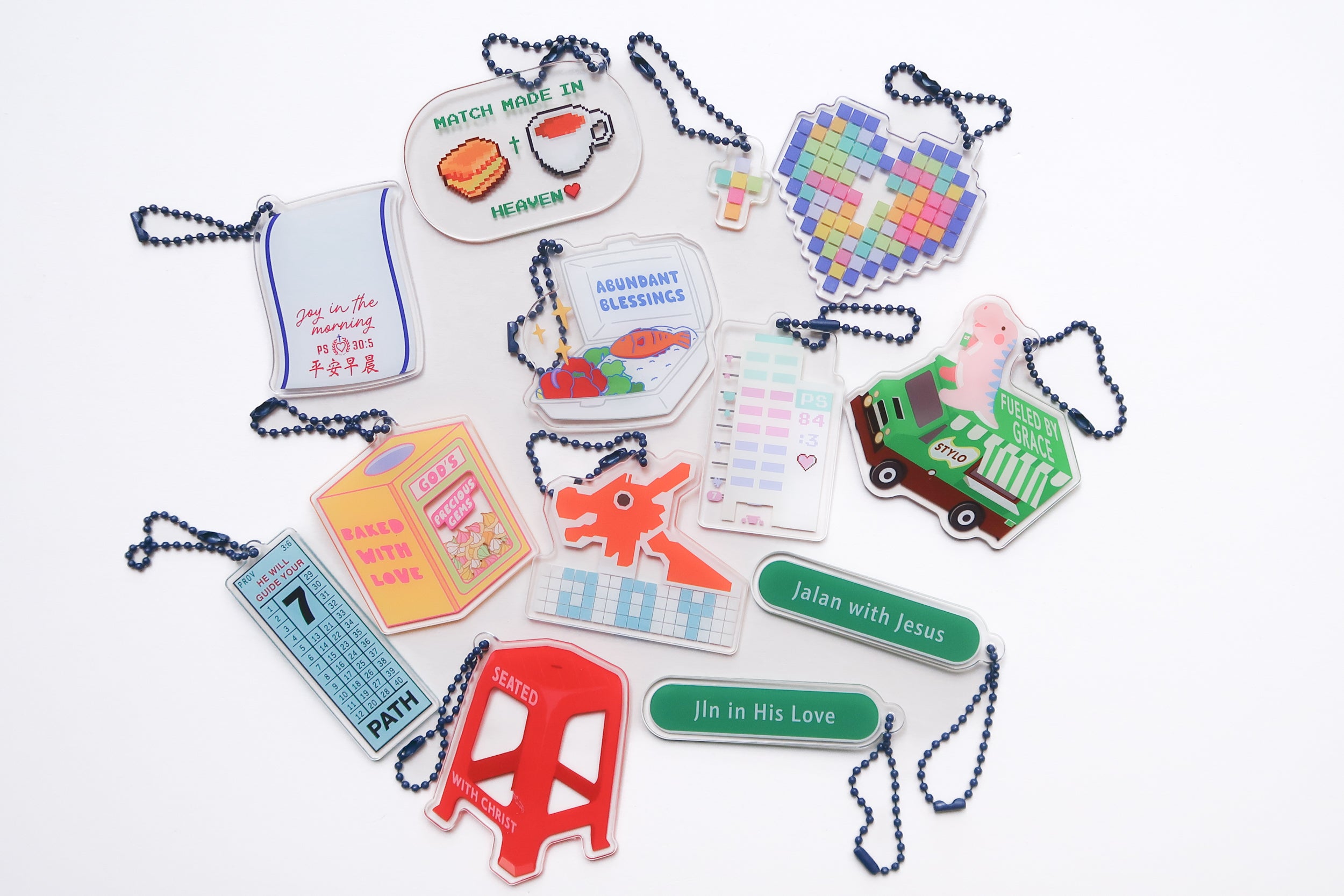 Variety of acrylic keychains with Christian themes, featuring Bible verses and inspirational messages, from The Commandment Co, Singapore.