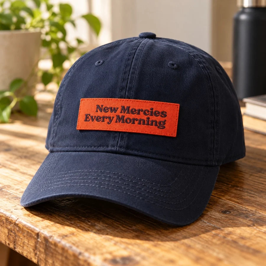 New Mercies Every Morning embroidered Velcro tag attached to a navy baseball cap