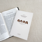 Open notebook "God will always be by your side" placed next to a Bible, showcasing the beautiful design and inspirational message from Jeremiah 31:3.