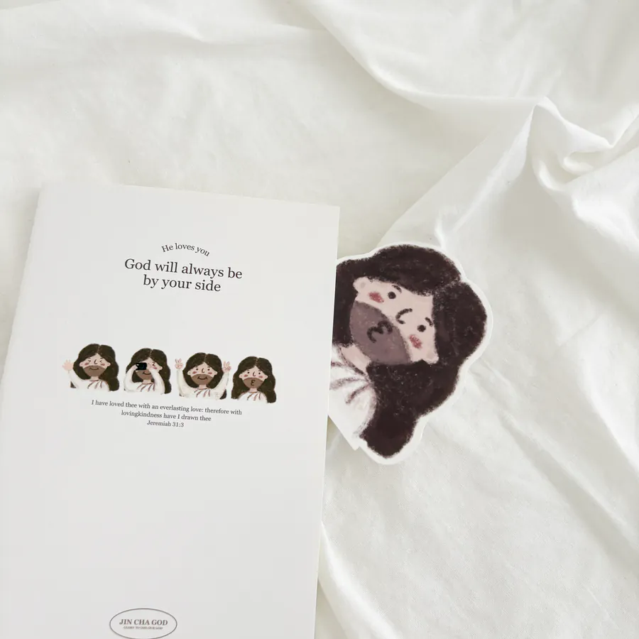 Notebook titled "God will always be by your side" featuring adorable illustrations and the scripture from Jeremiah 31:3, accompanied by a cute character bookmark