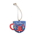 Blue cup-shaped Christmas bauble with a red handle, floral details, and the word ‘Overflow’