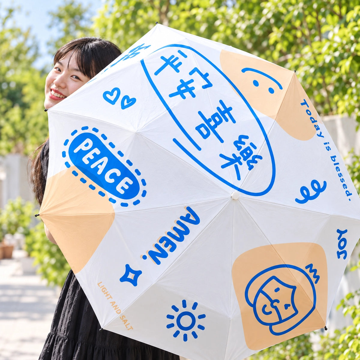 Peace and Joy Christian umbrella opened outdoors in bright daylight