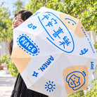 Peace and Joy Christian umbrella opened outdoors in bright daylight