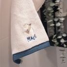Peace Christian cotton towel with embroidered wording.