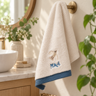 Peace embroidered Christian cotton towel hanging in a bright bathroom