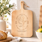 Peace I Leave With You wooden cutting board styled in a bright kitchen lifestyle setting.