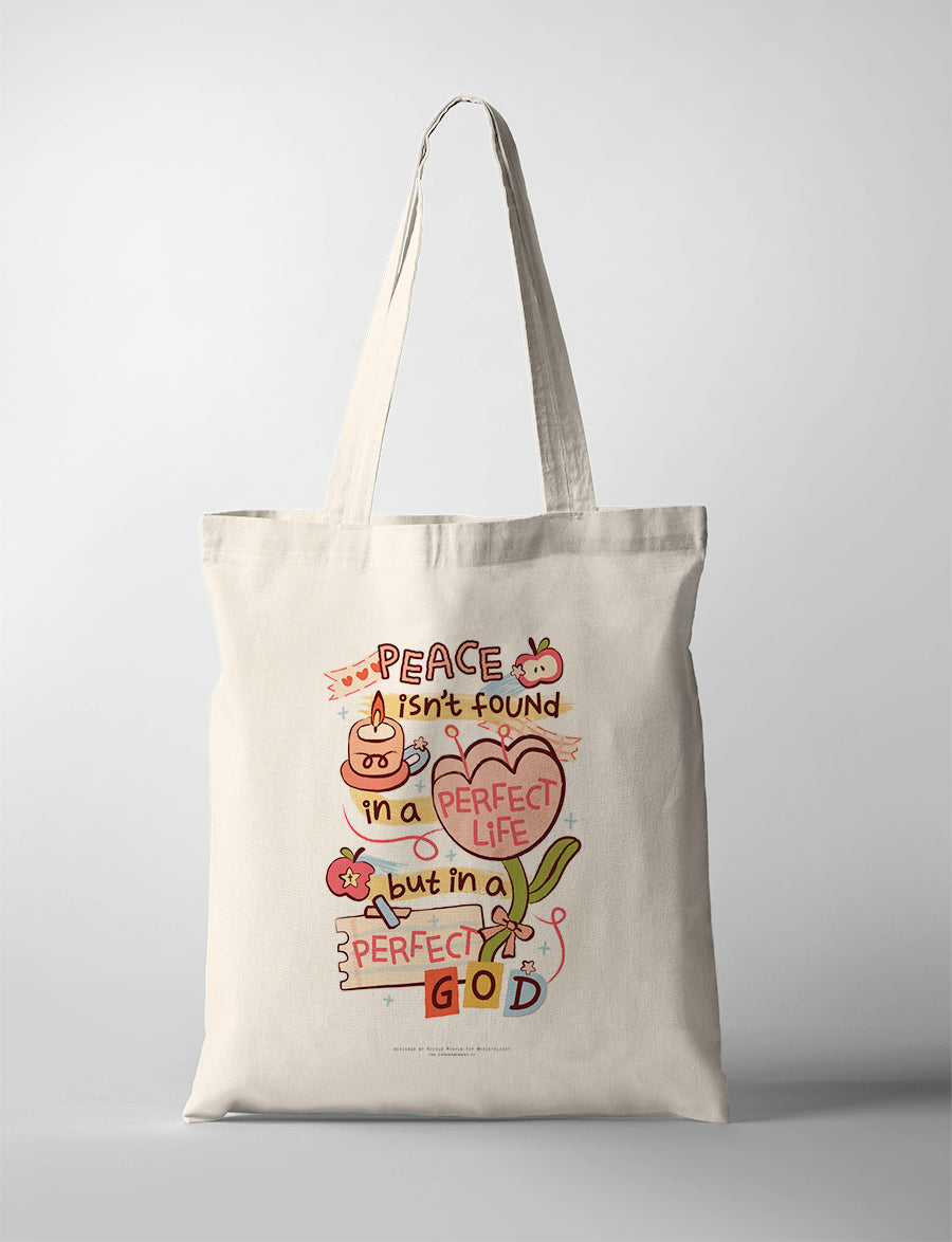 Christian tote bag featuring “Peace isn’t found in a perfect life, but in a perfect God” with colourful floral artwork