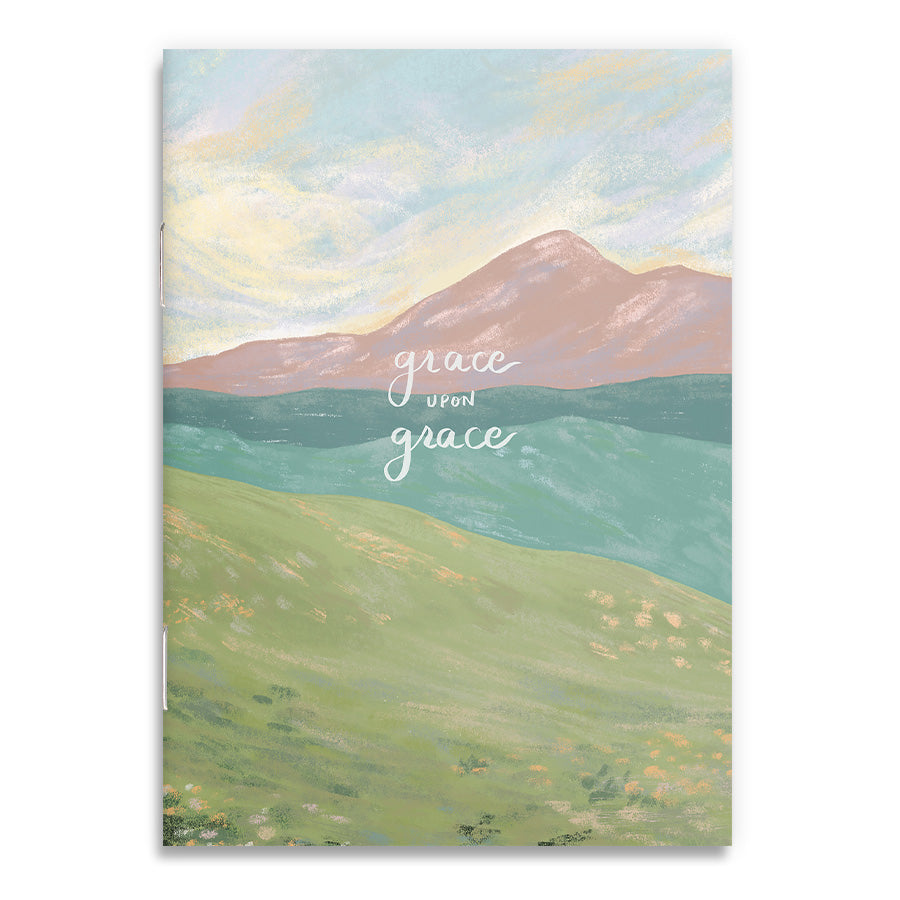 A6 notebook cover with 'Grace Upon Grace' text over a serene mountain landscape in pastel colors