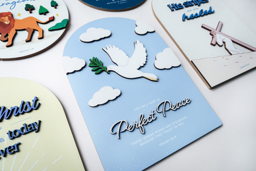 3D wooden Christian poster featuring a white dove with an olive branch, surrounded by clouds, with the phrase 'Perfect Peace' and the Bible verse Isaiah 26:3.