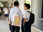 Personalised Teacher’s Day tote bag worn by a teacher in a school corridor with custom notebook-inspired design