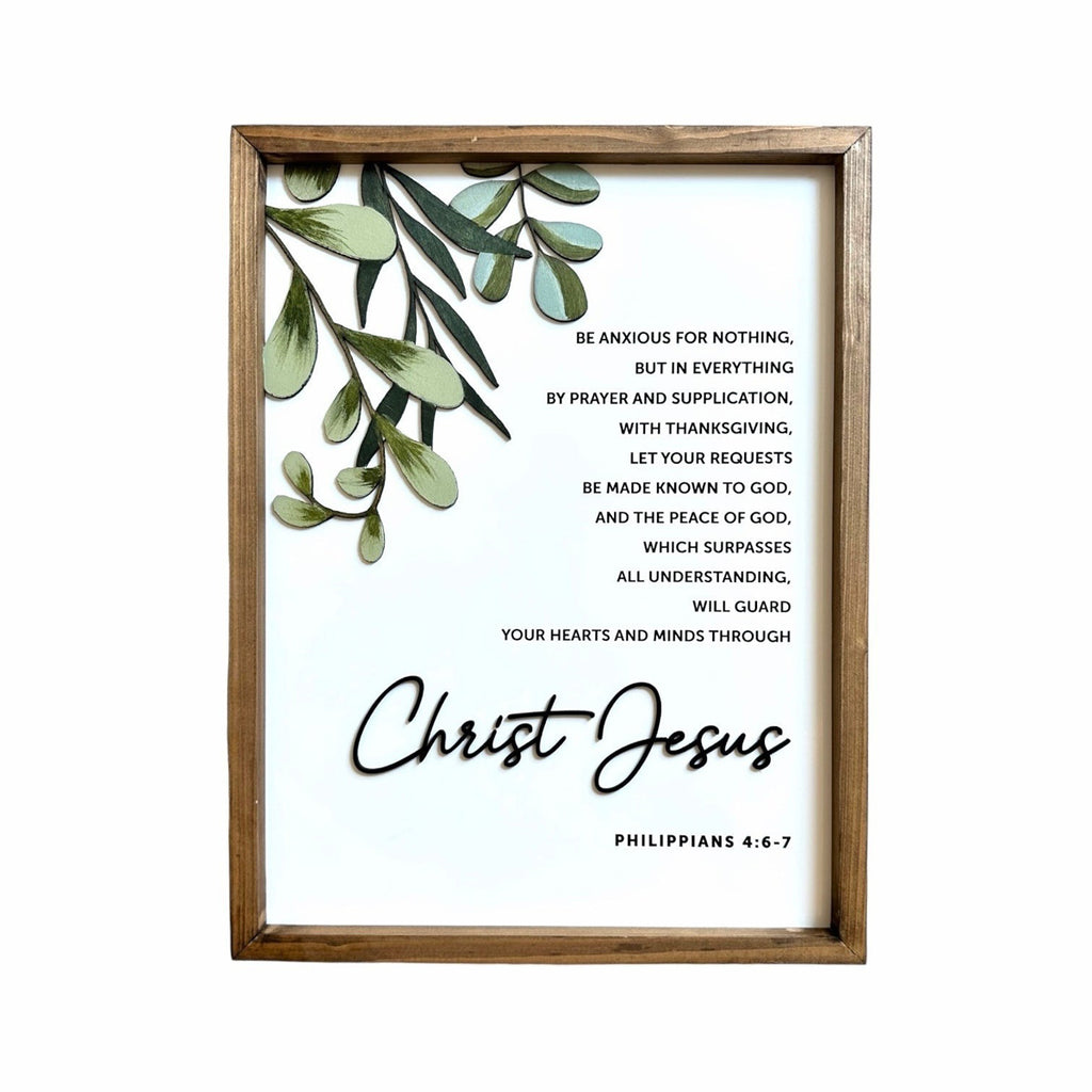 Framed Christian wall art featuring Philippians 4:6-7 with a greenery illustration and the words 'Christ Jesus' in elegant script.