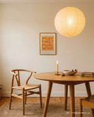Pray First Panic Never Christian poster displayed above a wooden dining table in a warm neutral room