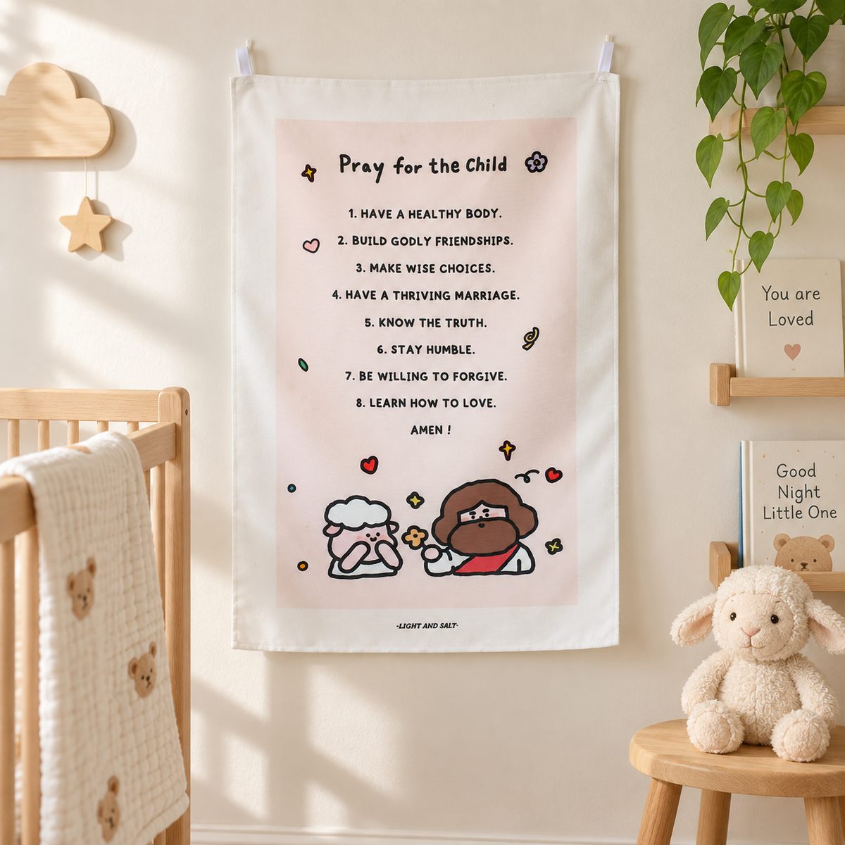 Pray for the Child Christian wall tapestry displayed in a bright nursery beside a wooden cot.