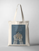 Christian tote bag featuring “Prone to leave the God I love, here’s my heart” with illustrated hands and flowers