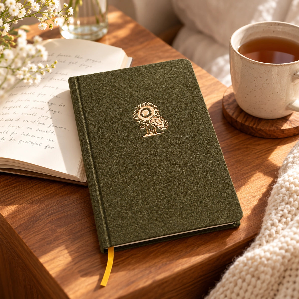 Protected Sunflower Christian fabric journal on a warm wooden table beside an open notebook and tea.