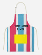  Colorful "Provision Store" apron with red, blue, and white stripes and a bright yellow pocket, featuring the uplifting message "Love, Joy & Daily Bread," inspired by simple happiness and daily provision.