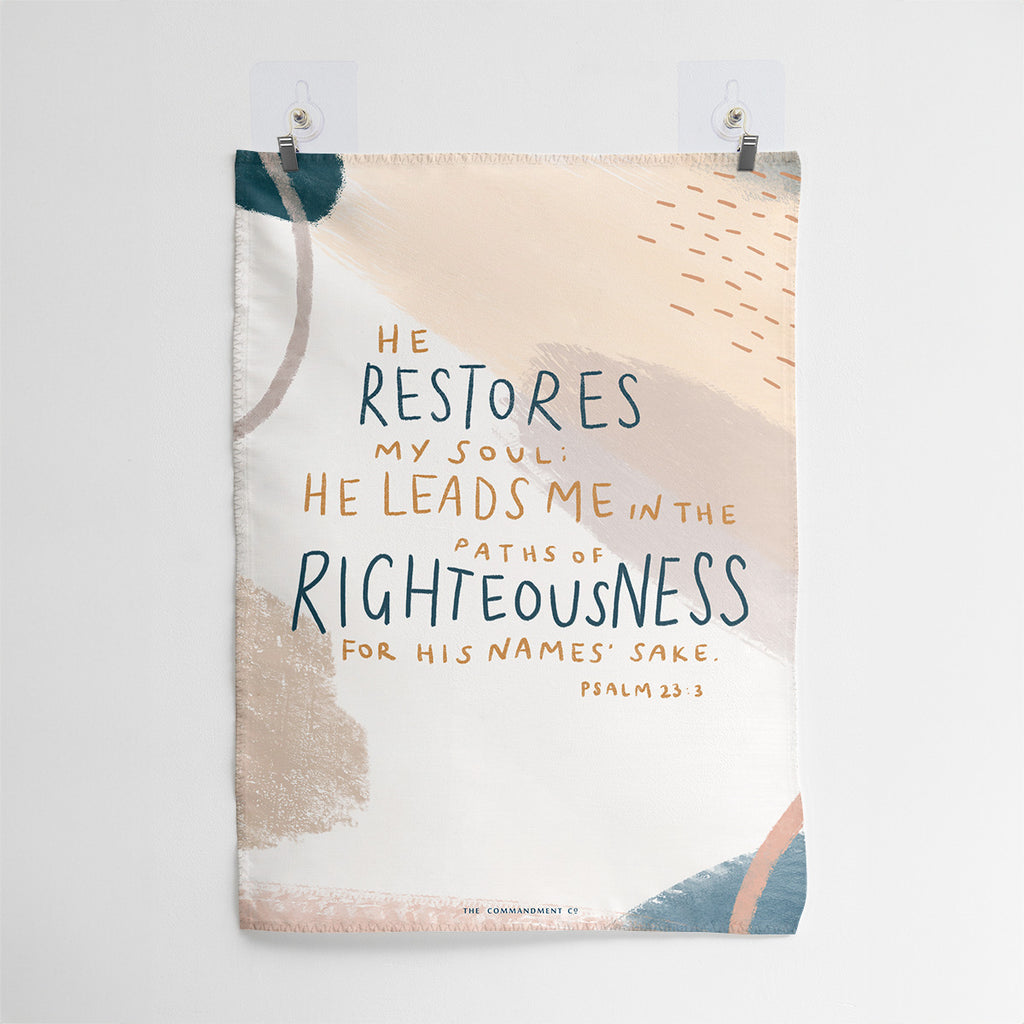 Christian wall art featuring Psalm 23:3, 'He restores my soul; He leads me in the paths of righteousness for His name's sake,' with an abstract beige and pastel design