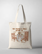 Canvas Christian tote bag featuring Psalm 23:5 illustration of a table with chairs and the phrase “You prepare a table before me” in a warm minimal design