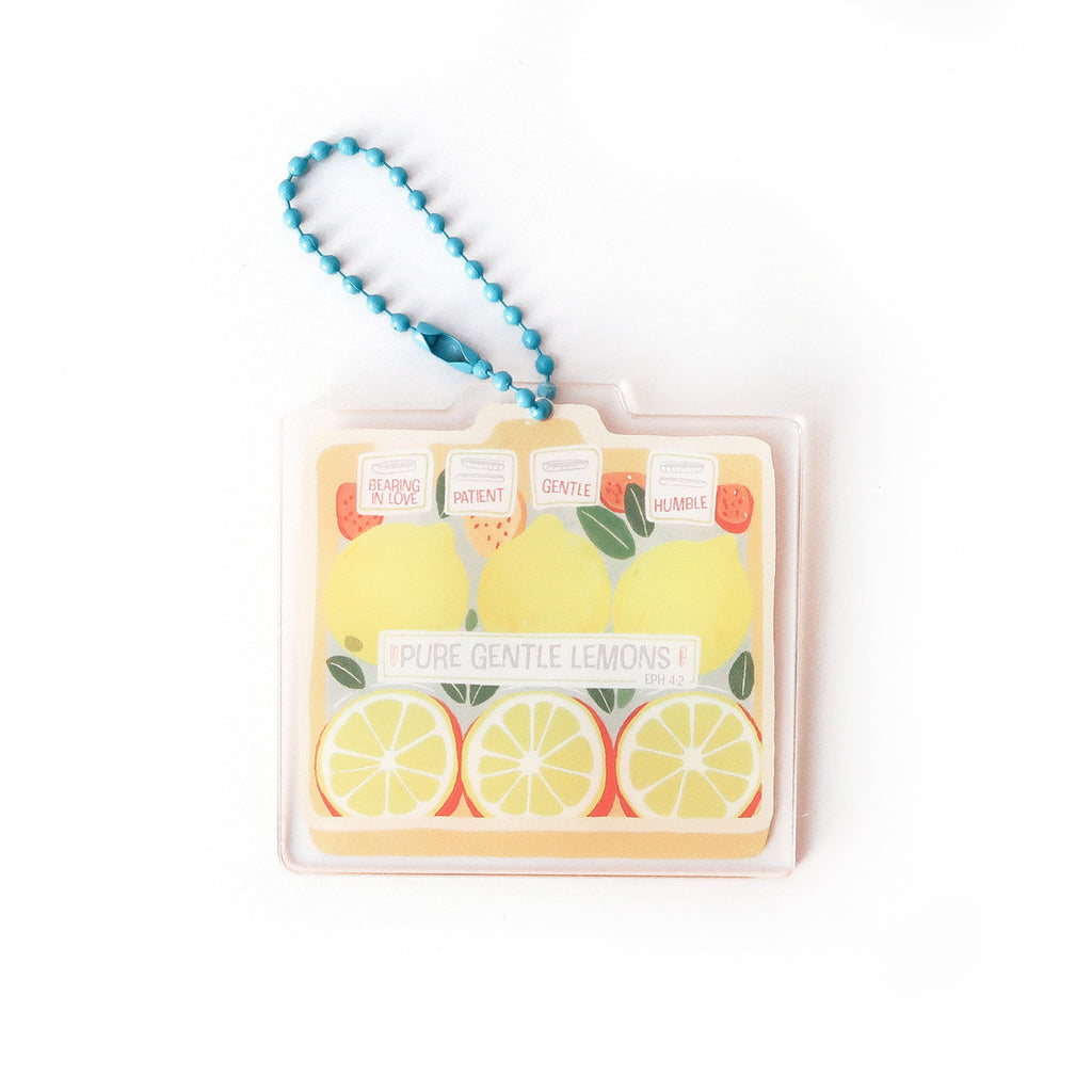 Christian keychain featuring a lemon design with the message 'Pure Gentle Lemons' and scripture reference Ephesians 4:2, symbolizing patience, humility, and love.