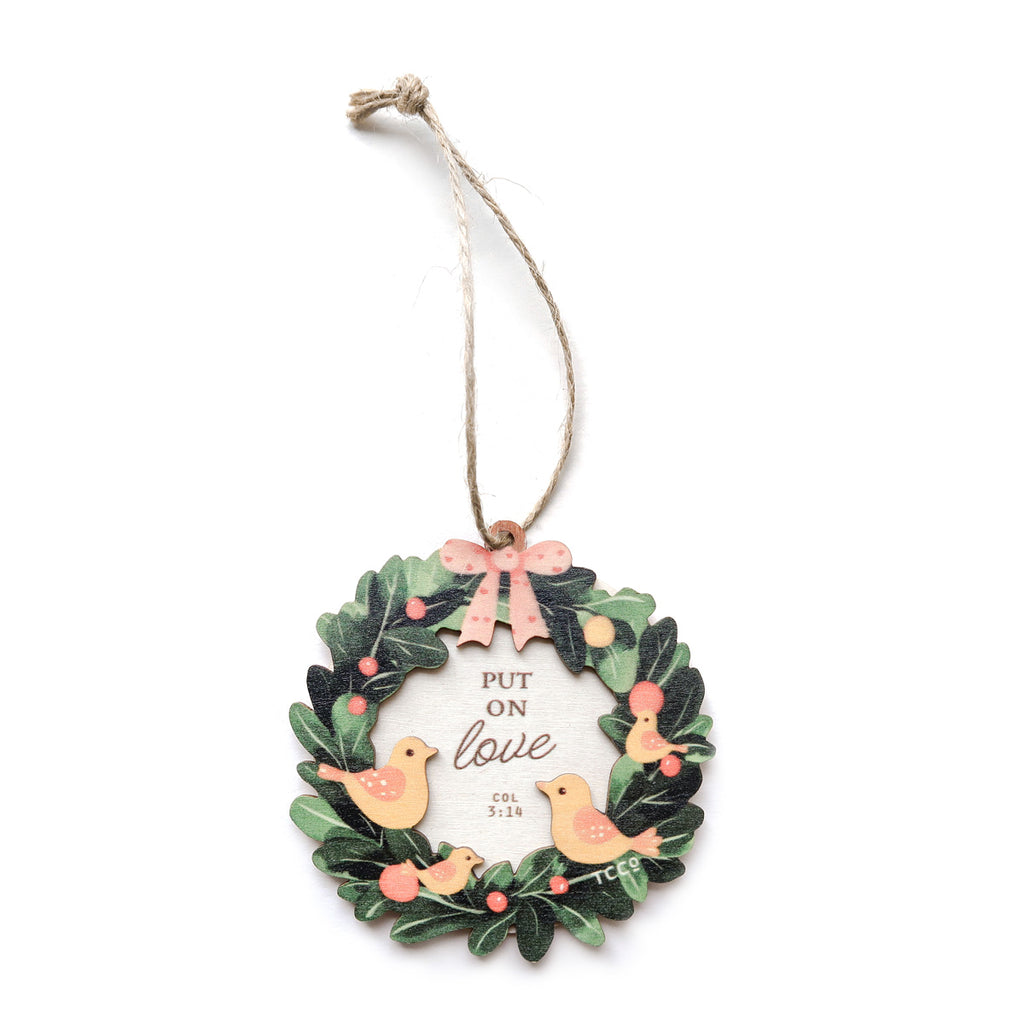 'Put on Love' Colossians 3:14 Christmas wreath ornament featuring birds, holly, and a pink bow, perfect for holiday decor.