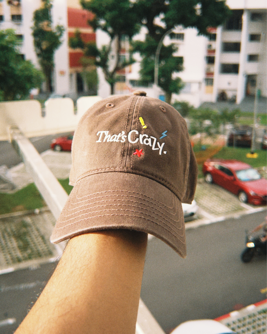 That's Crazy brown embroidered cap by Quite at Home styled for everyday wear.