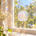 Rejoice and Be Glad suncatcher sticker on a sunlit window casting rainbow reflections